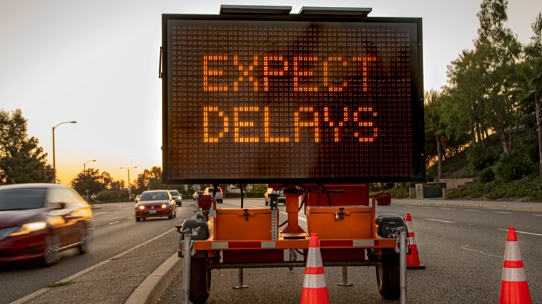 Street sign reading "Expect Delays"