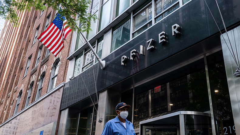  Pedestrians wearing a protective mask walks past Pfizer Inc. headquarters on July 22, 2020 in New York City.