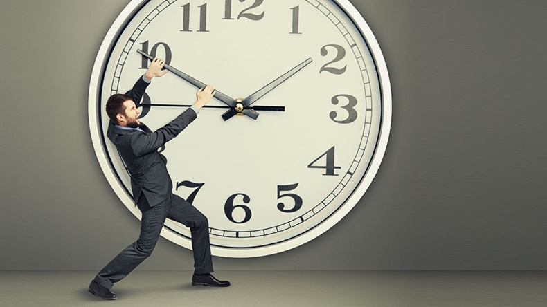 yelling businessman trying to stop a time. man and big clock over dark background