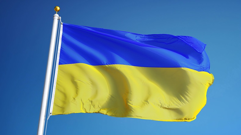 Ukraine flag waving against clean blue sky, close up, isolated with clipping path mask alpha channel transparency