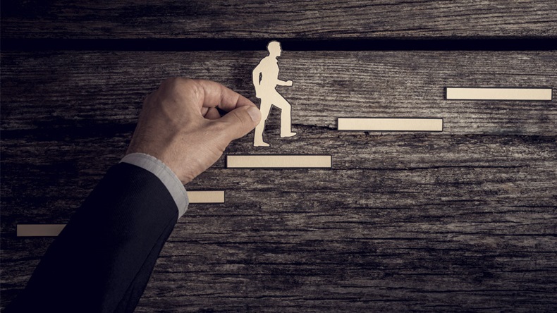 Retro style image of a successful businessman climbing the corporate ladder using paper cutouts. - Image 
