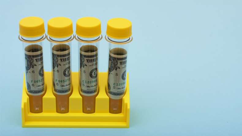 A set of yellow test tubes on a blue background, medical research costs - Image 