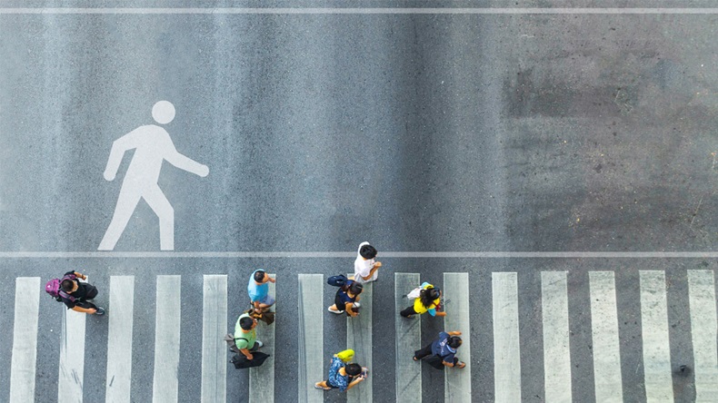the top view of group people walk on crosswalk pedestrian walkway with the white signage symbol of people walk on the road - Image 