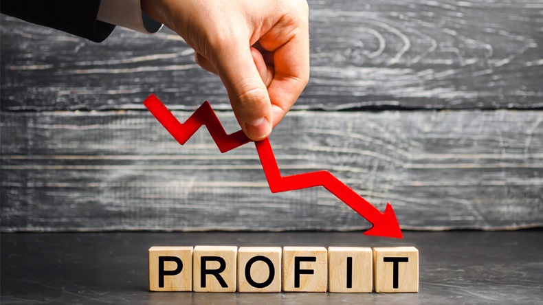 A businessman holds a red arrow to down and the inscription "profit". Unsuccessful business and poverty. Profit decline. Loss of investment. Low wages. Economic crisis. The fall of the financial - Image 