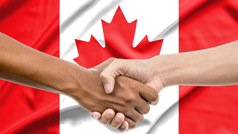 Handshake - Hand holding on Canada flag background - Image 