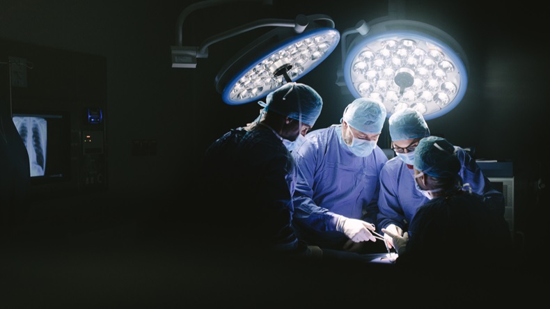 Medical team performing surgery. Group of surgeons in hospital operation theater. - Image 