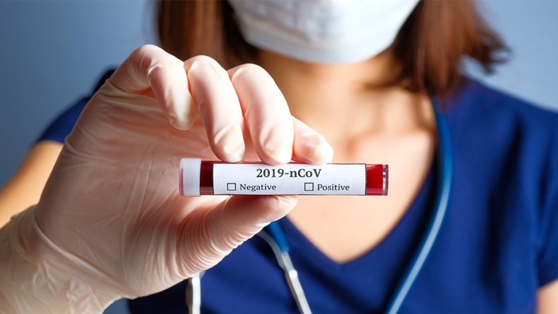 Nurse holding test tube with blood for 2019-nCoV analyzing. Novel Chinese Coronavirus blood test Concept.