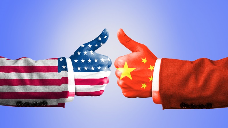 USA and China flag print screen on like hand symbol with white background.It is symbol of economic tariffs trade war and tax barrier between United States of America and China.