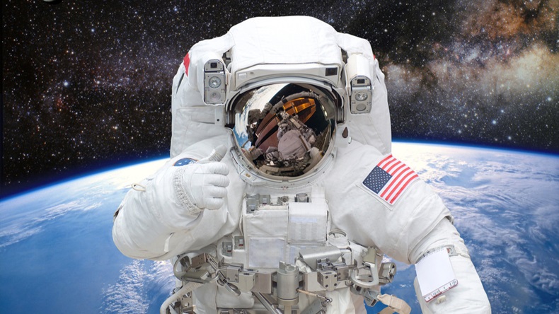 Astronaut on space mission with earth on the background. Elements of this image furnished by NASA. C  By Castleski