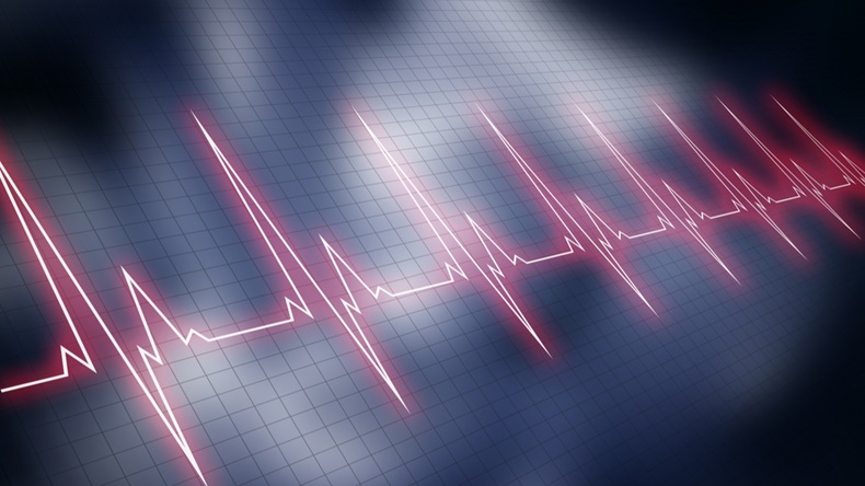 Red cardiogram graphic line over blue blurry image of cardiopulmonary resuscitation. Vital signs.