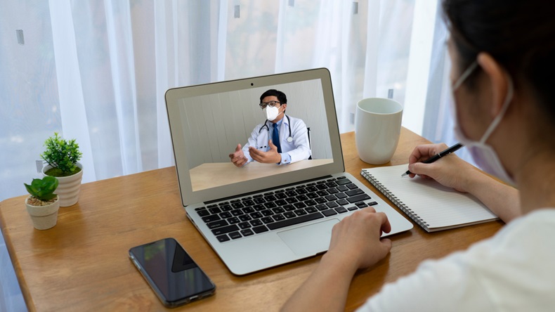 woman patient who got fever and cough suspected of covid-19 or coronavirus infection consult asian doctor via vdo call. telemedicine and new normal lifestyle concept
