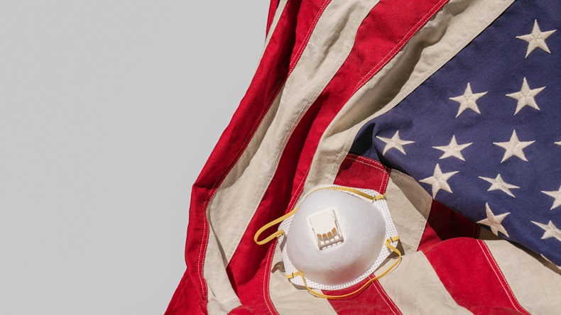 American Flag with face mask on light gray background