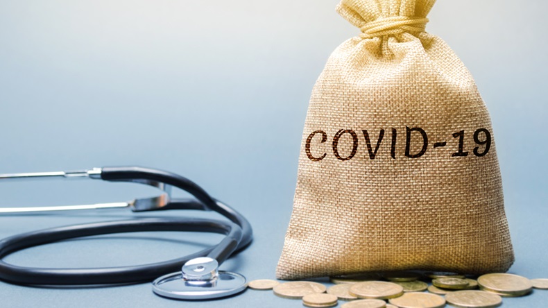 Money bag with the word Covid-19 and a stethoscope. Coronavirus pandemic infection. Healthcare, medicine concept. Money for treating infected people.