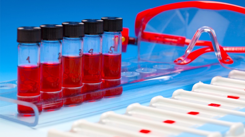 Array of blood samples for microscopy and biopsy tissue on blue gradient background
