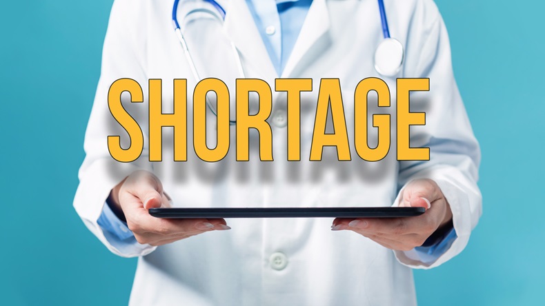 Covid-19 Shortage theme with a doctor using a tablet computer, drug shortage