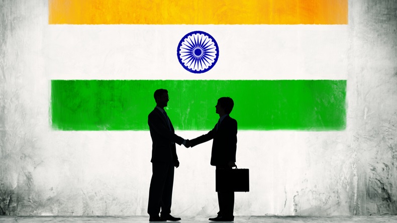 Two Businessmen Shaking Hands With Flag of India