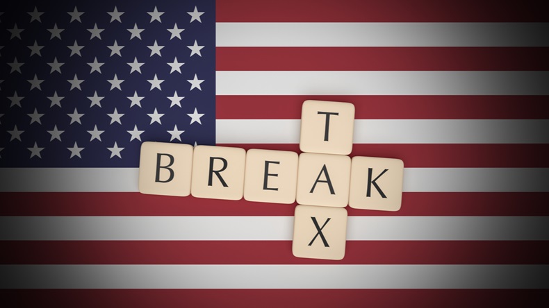 USA Politics Concept: Letter Tiles Tax Break On US Flag, 