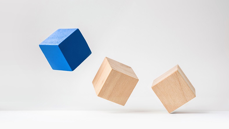 Abstract geometric real wooden cube with surreal layout on white floor background