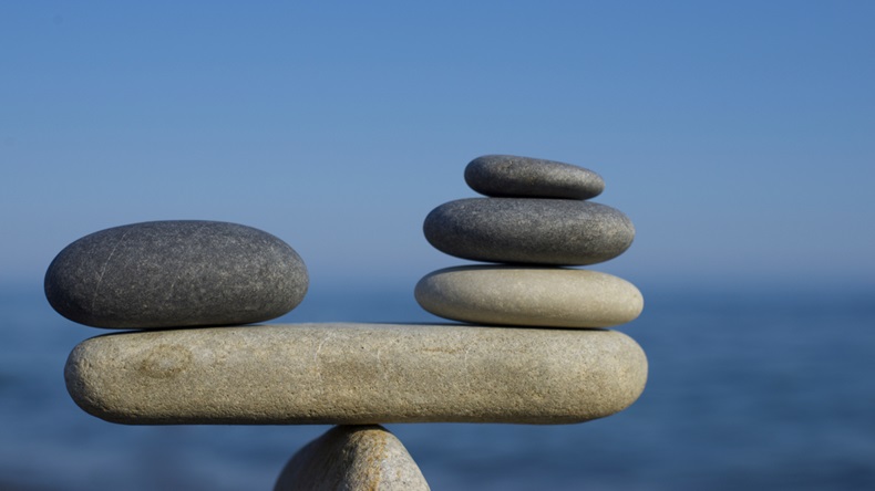 Balancing stones on a blue sky and sea background.
