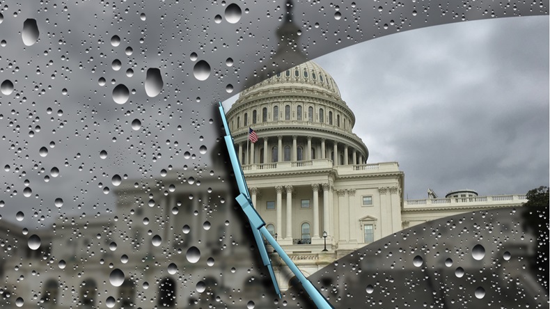 United States congress blurred by rain with a wiper cleaning a window as a symbol for government transparency.