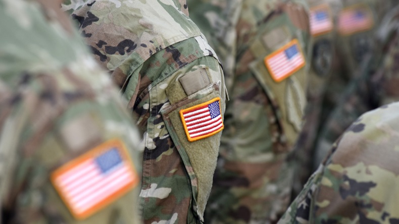 American soldiers and flag of USA on soldier's arm.