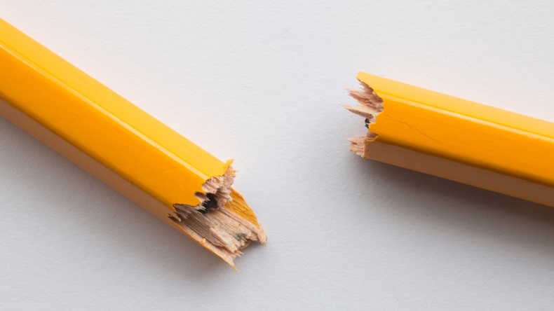 Close up of yellow pencil snapped or broken in two