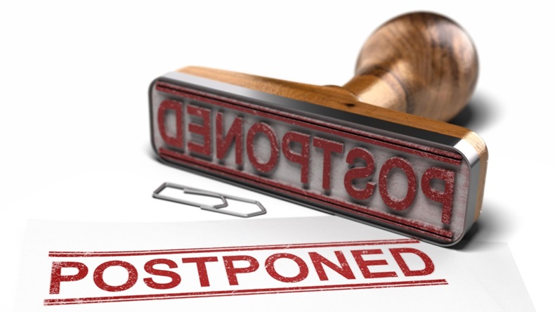 Rubber stamp with the word postponed