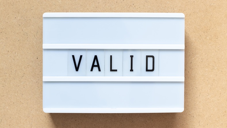 The word valid on a white sign board.