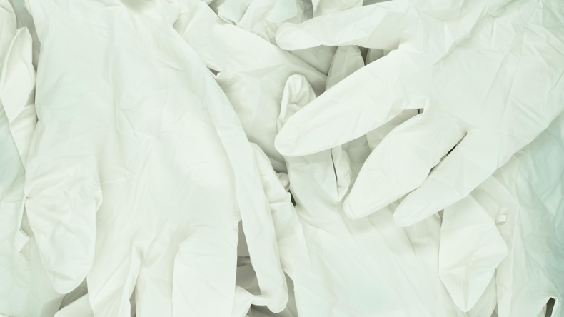 Large amount of white latex gloves background surface.