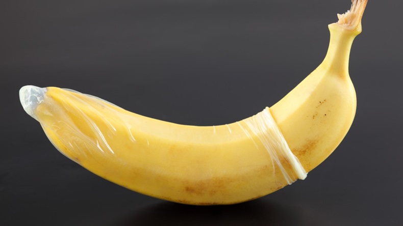 Condom unrolled to cover a banana.