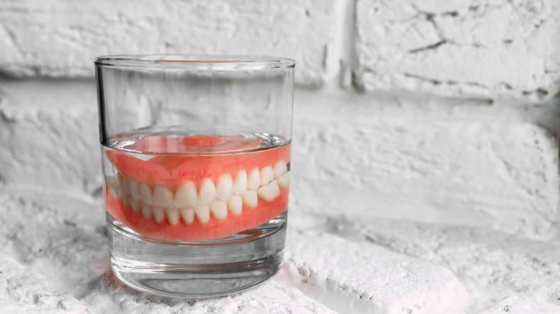 A denture in a glass of water. 