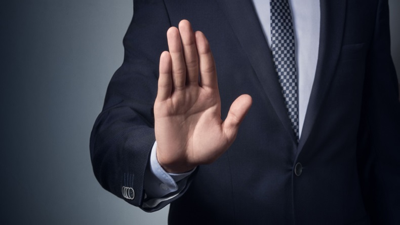 image of man in suit gesturing "no" 