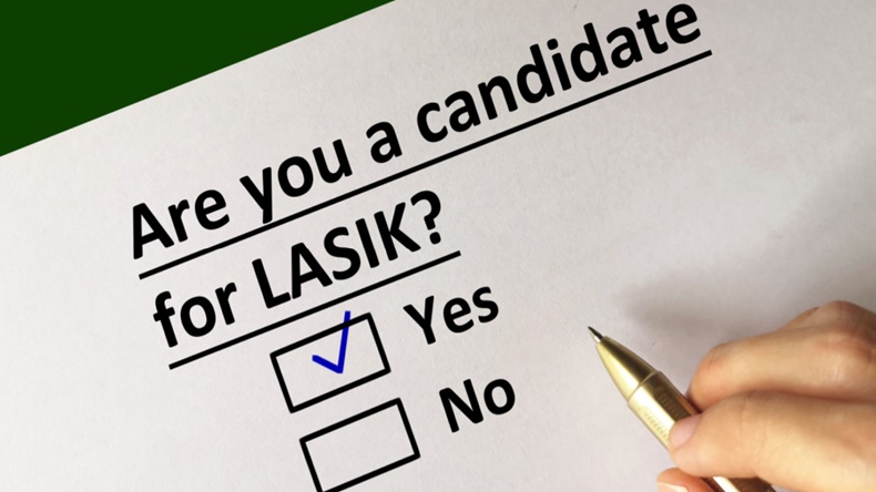 Hand hovering over checkmarks on page reading, "Are you a candidate for LASIK?".