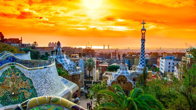View of the city from Park Guell in Barcelona, Spain with sunrise colors.