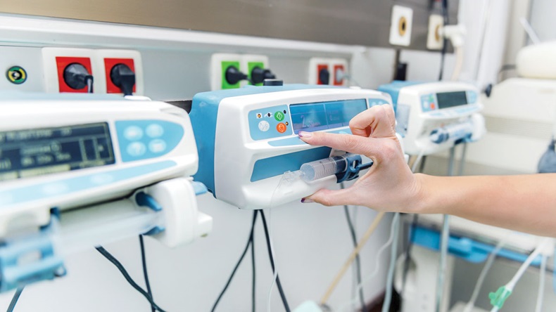 Intensive care infusion pump adjusted by a doctor hand