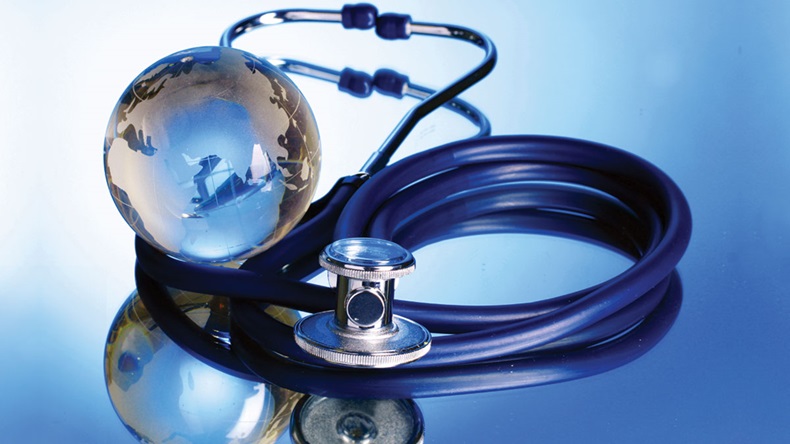 Globe and stethoscope on blue background