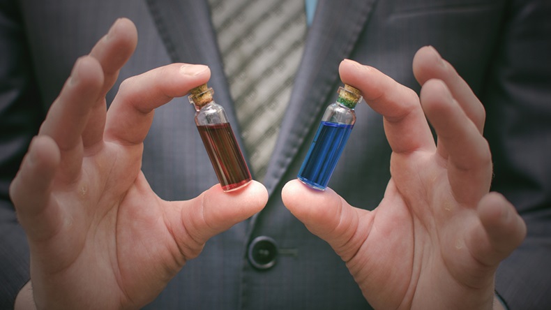 Blue and red pill essential liquid in business man hands. Choosing of right pill. Steroid or drug presentation. Medication for all diseases concept. Antibiotic pill comparison.
